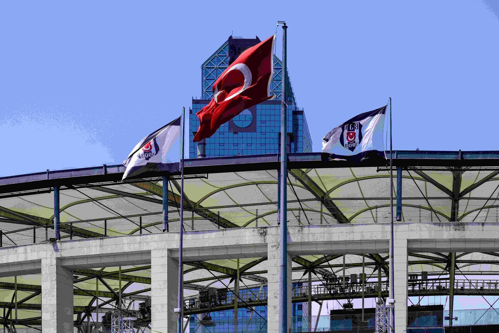 Business and organization flags displayed outside an office building